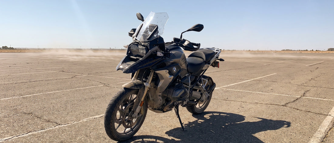 3D mesh motorcycle seat cover topic: BMW R1250GS adventure bike parked in a sunny parking lot