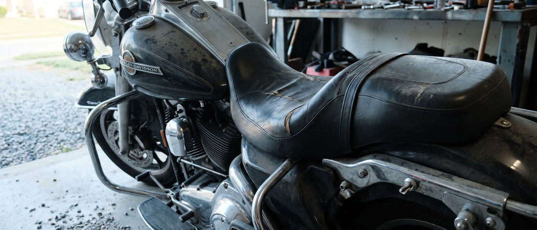 Harley Davidson replacement seat covers topic: worn Road King parked in a shaded garage at early morning