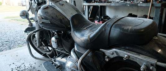 Harley Davidson replacement seat covers topic: worn Road King parked in a shaded garage at early morning