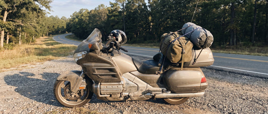 Motorcycle rear seat luggage strapped to a Honda Gold Wing loaded for a long haul at dawn