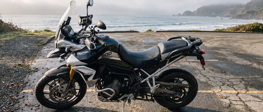 Triumph motorcycle seat covers guide: Triumph Tiger 900 parked on a coastal pull-off at early morning